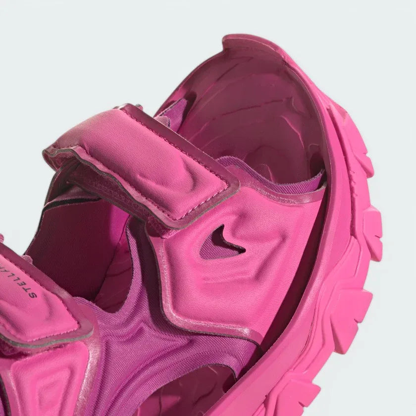 Close-up zoom on the straps of the Adidas by Stella McCartney Hika Sandal, showing the texture of the material and the collaborative Adidas by Stella McCartney logo.