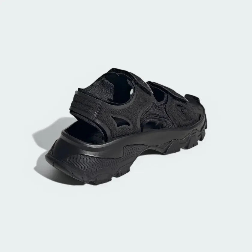 Rear view of the Adidas by Stella McCartney Hika Sandals in black, focusing on the heel strap and branding.