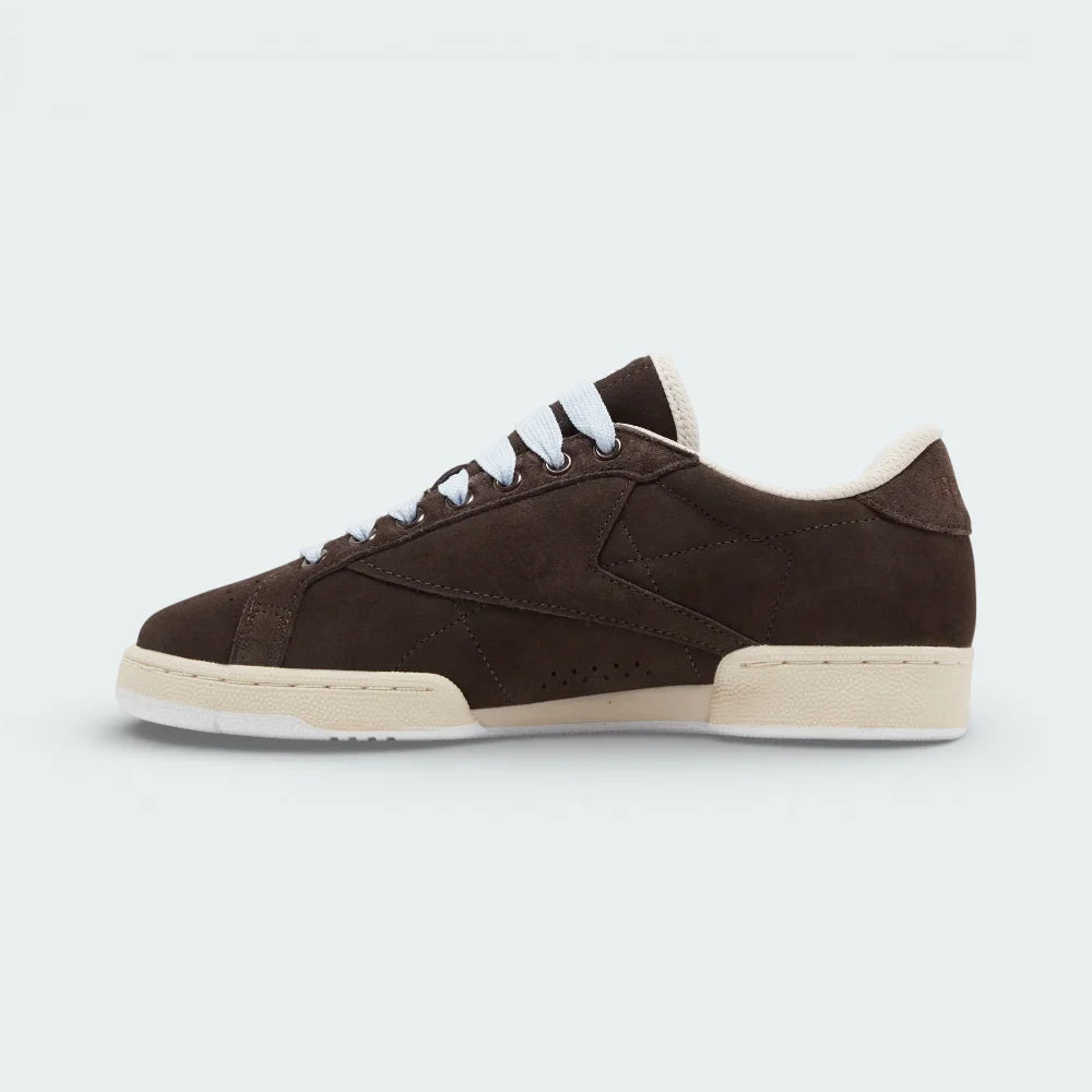 Side profile of the Reebok x SNEEZE Club C Grounds in Earth brown suede, on the inside showing the tonal side stripes and the contrasting Stucco white rubber outsole.