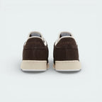 Rear view focusing on the structured suede heel and the precise stitching that connects the upper to the Stucco midsole.