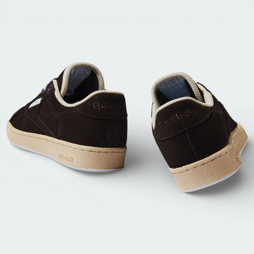 Rear view focusing on the structured suede heel and the precise stitching that connects the upper to the Stucco midsole.