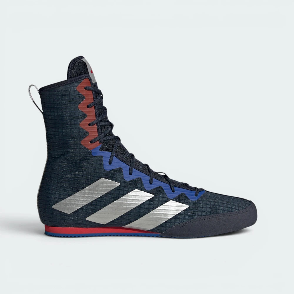 Highlights the high-velocity sweep of the Silver Metallic 3-Stripes, showing the breathable mesh depth of the Legend Ink upper rising into the supportive mid-cut ankle collar above the grey EVA foam wedge.