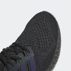 Close-up zoom on the front of the Adidas Ultra 4D x Rich Mnisi Pride men's trainers, showing the colorful Primeknit texture and unique lacing system.