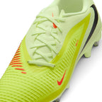Macro focus on the forefoot and lacing area, detailing the textured NIKESKIN ribs, Hyper Crimson accent lines, and lime green laces.