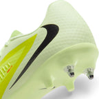 Close-up of the heel transition highlighting the metal screw-in stud placement, integrated traction fins, and the sleek black side Swoosh.