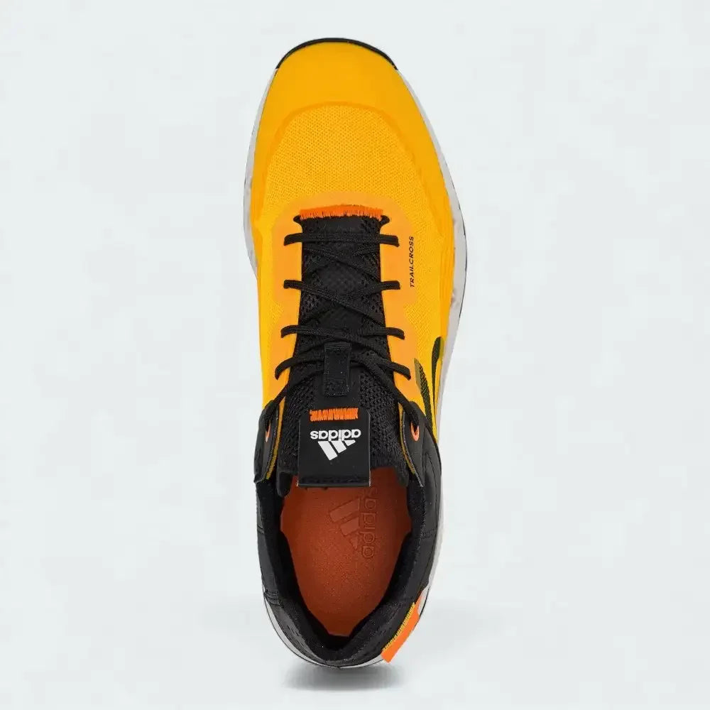 Top-down view of a pair of Adidas Five Ten Trailcross LT shoes in gold, highlighting their streamlined silhouette and lacing system.