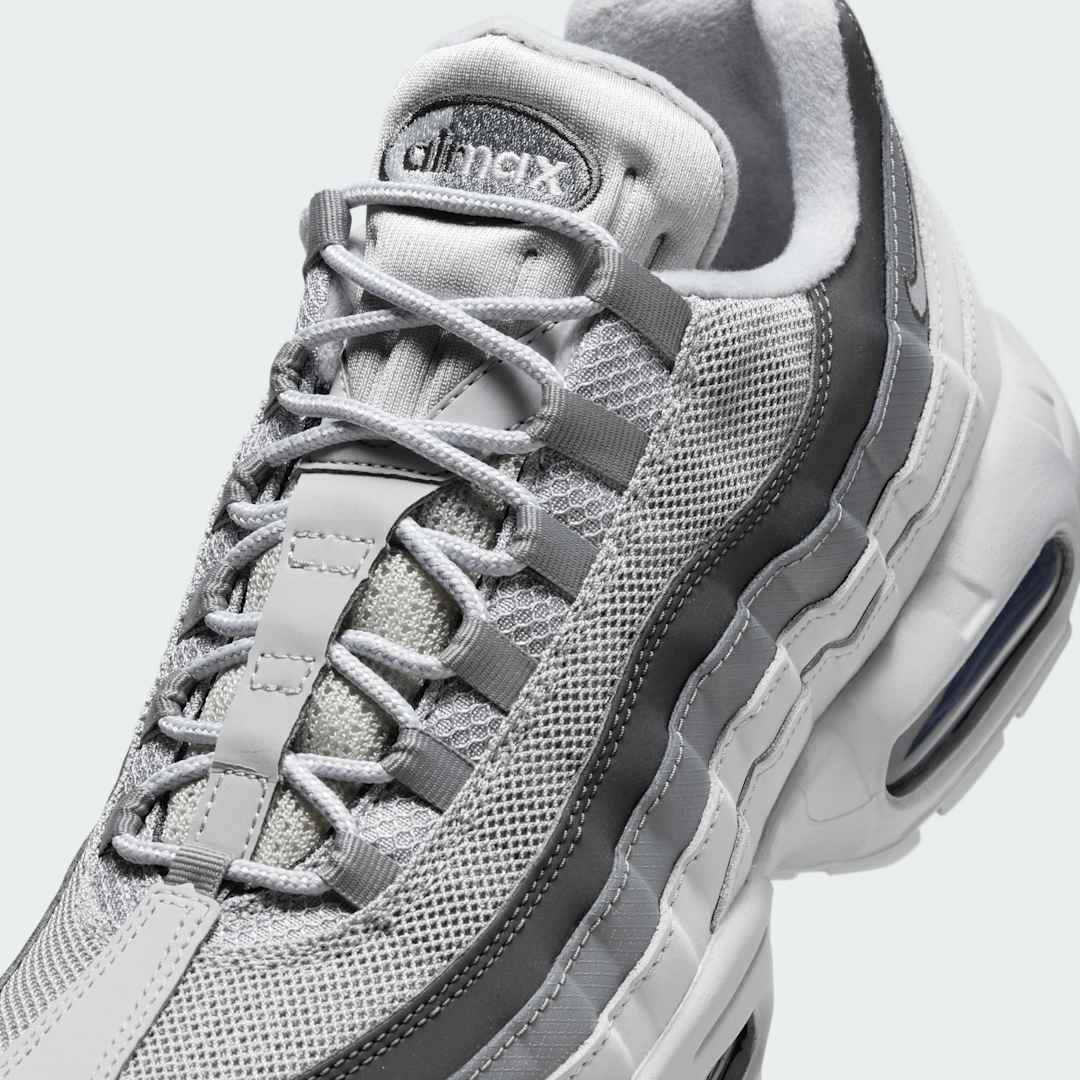 Close-up zoom on the front of the Nike Air Max 95 Men's running shoes, showing the intricate lacing system, mesh tongue, and layered overlays.