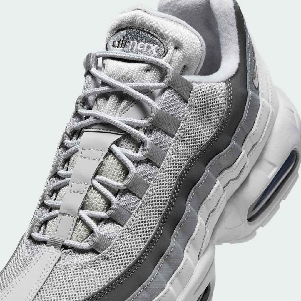 Close-up zoom on the front of the Nike Air Max 95 Men's running shoes, showing the intricate lacing system, mesh tongue, and layered overlays.