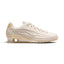 Side Profile Image: Studio lateral shot of the Nike Women's Shox Z in Oatmeal and Phantom Linen, highlighting the textured neutral mesh upper, sculpted synthetic mudguard, miniature white Swoosh, and iconic Shox cushioning columns in the heel.   