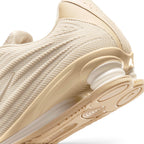 Zoom Looking at the Outsole and Midsole: Detailed close-up angle capturing the structural interaction between the supportive foam midsole wedge, the durable rubber outsole pods, and the springy Shox heel columns.   