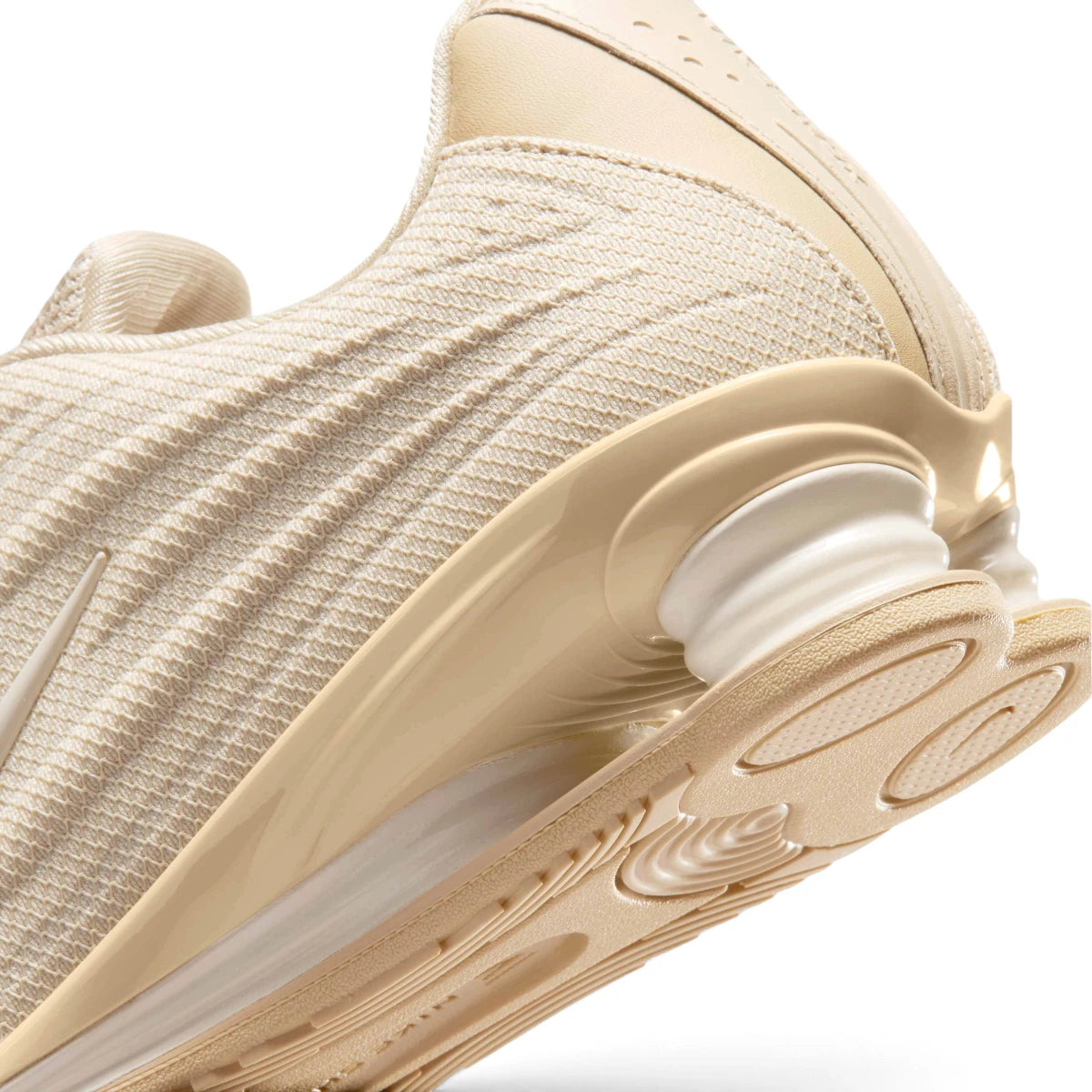 Zoom Looking at the Outsole and Midsole: Detailed close-up angle capturing the structural interaction between the supportive foam midsole wedge, the durable rubber outsole pods, and the springy Shox heel columns.   