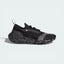 Side profile of the black and white Stella McCartney Ultraboost, showing the sleek PRIMEKNIT upper and the thick Light BOOST midsole.
