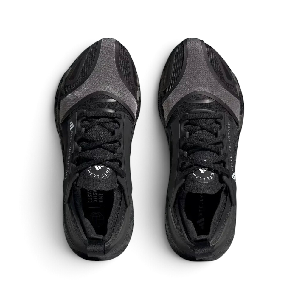Top-down view of the running shoes, highlighting the engineered mesh inserts and the integrated Stella McCartney branding on