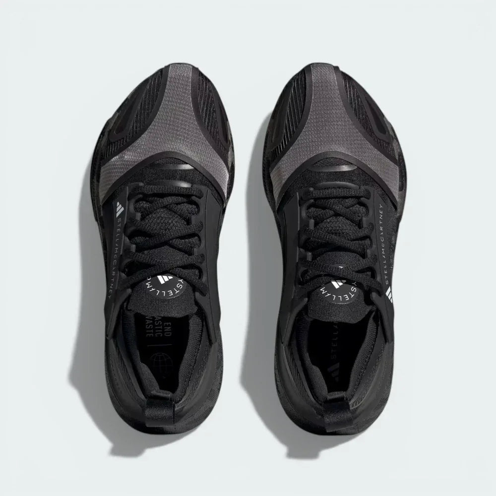 Top-down view of the running shoes, highlighting the engineered mesh inserts and the integrated Stella McCartney branding on
