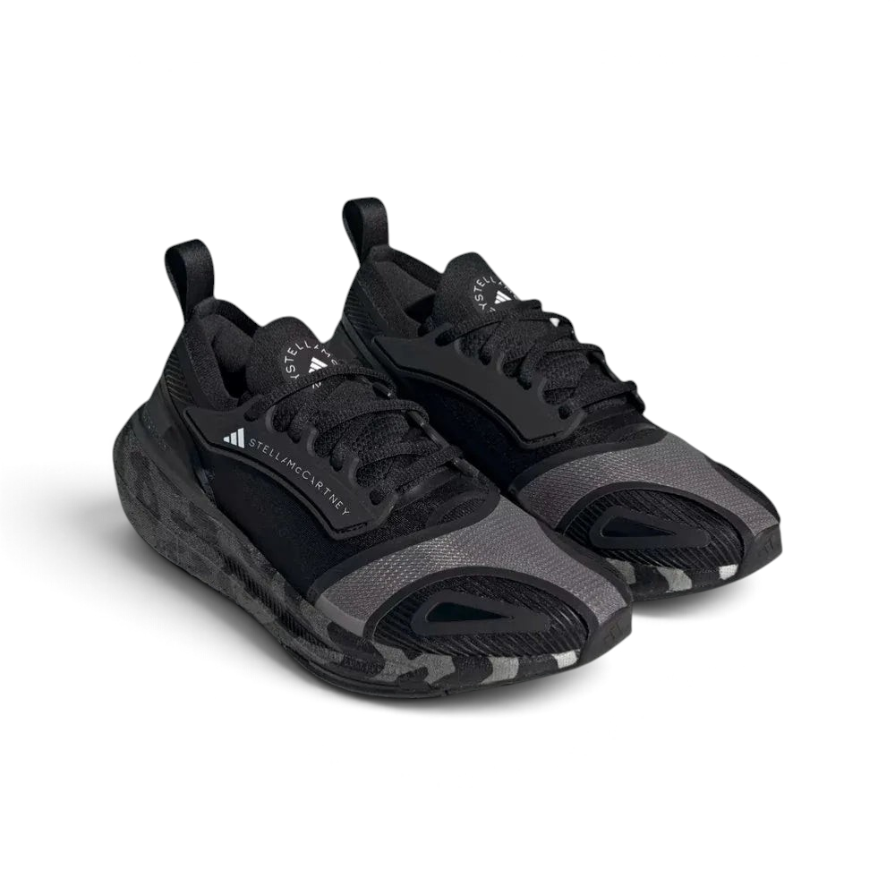 Three-quarter view of the pair, showcasing the contrast between the core black knit and the crisp cloud white midsole.