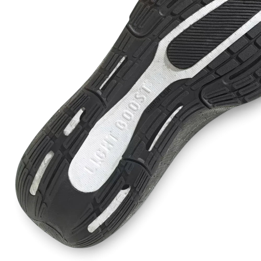 Detailed zoom on the Light BOOST foam, showcasing the pebbled texture of the cushioning and the precision bonding to the upper.