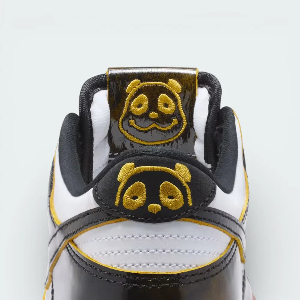 Close-up of a sneaker with panda face design on a white background