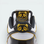 Close-up of a sneaker with panda face design on a white background