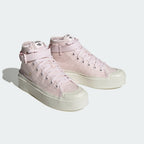 Emphasising the elevated, chunky retro basketball stance and the professional harmony of the pastel pink canvas panels resting against the thick platform base.