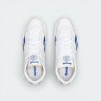Top-down view of the white leather trainers, highlighting the exposed foam tongue and the clean, traditional lacing system.