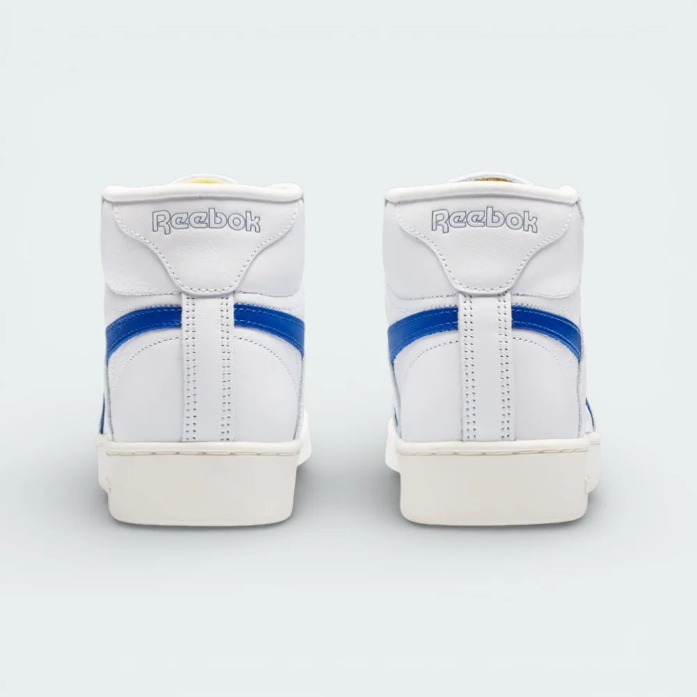 Rear view focusing on the high-top collar construction and the precise tonal stitching on the white leather heel.