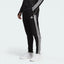 Side profile of the black Adidas Tiro 23 training pants, showcasing the slim tapered fit and the iconic white Three Stripes.
