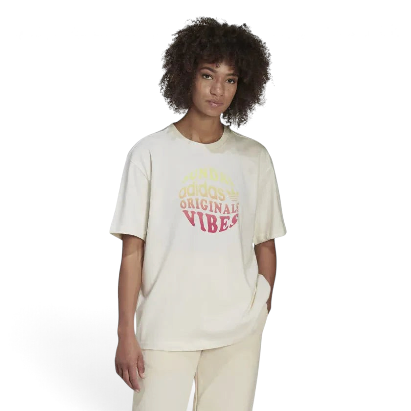 Trade Sports model wearing an Adidas chalk white cotton boyfriend t-shirt with a circular Sunday Vibes graphic print