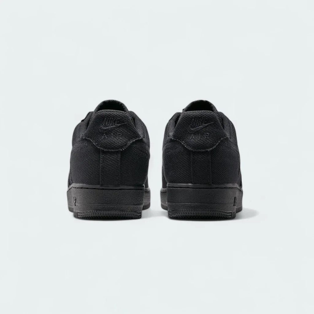 Rear view of the Nike Air Force 1 Low Canvas Men's black trainers, focusing on the heel panel and Nike Air branding.