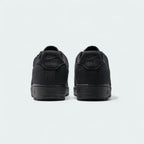 Rear view of the Nike Air Force 1 Low Canvas Men's black trainers, focusing on the heel panel and Nike Air branding.