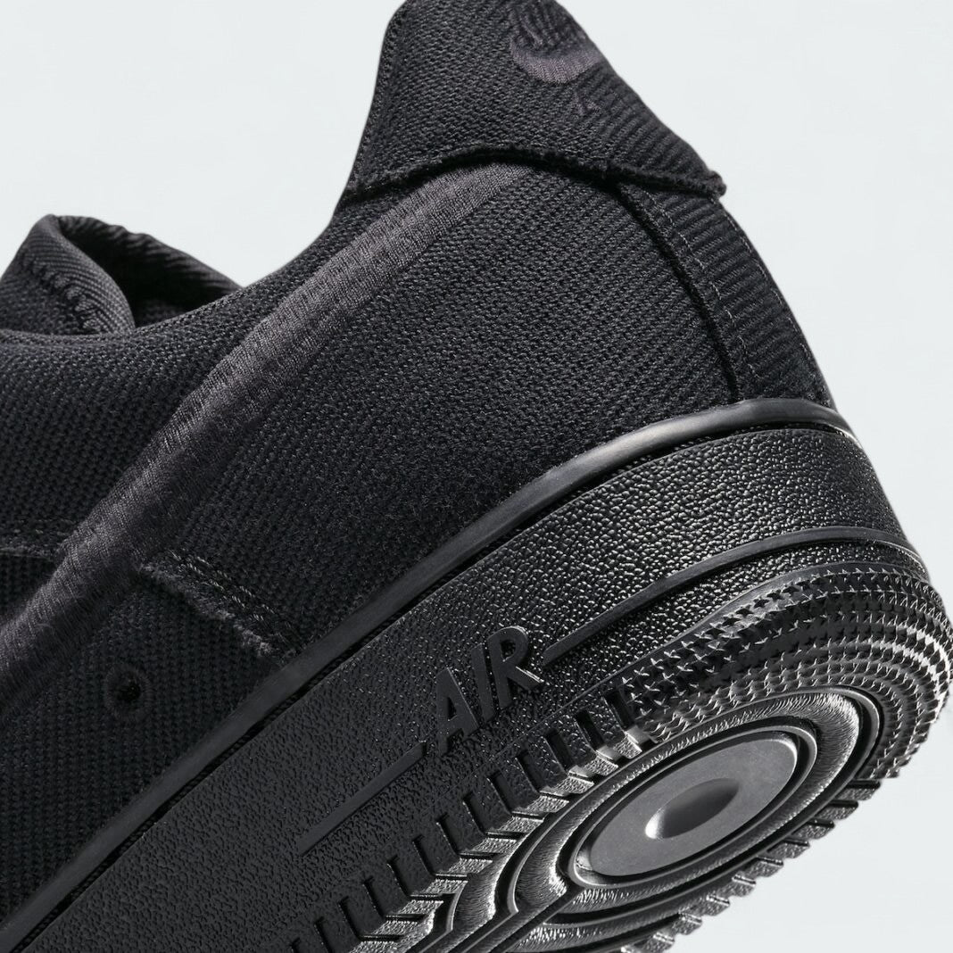 Detailed zoom on the outsole and midsole of the Nike Air Force 1 Low Canvas Men's trainers, highlighting the cushioned midsole and durable rubber outsole.