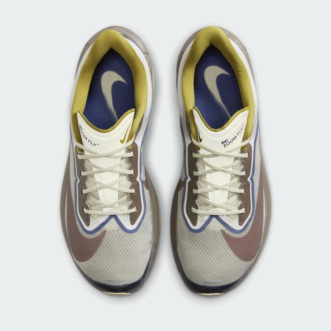 Top-down view of a pair of Nike ZoomX Invincible Run Flyknit 4 Men's running shoes in brown, highlighting the Flyknit construction and lacing system.