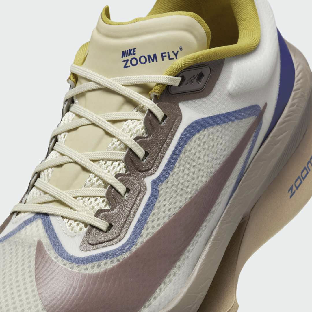 Close-up zoom on the front of the Nike ZoomX Invincible Run Flyknit 4 Men's running shoes, showing the Flyknit upper texture and integrated lacing system.