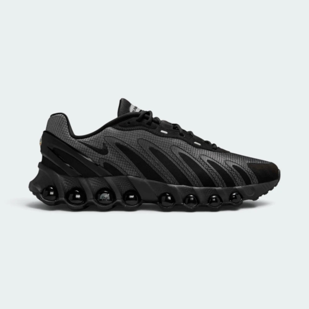 Highlights the sleek lateral profile featuring eight visible pressurised Air tube windows embedded along the sole, a dark grey texturised upper, subtle white Nike Swoosh, and the plastic heel containment clip.