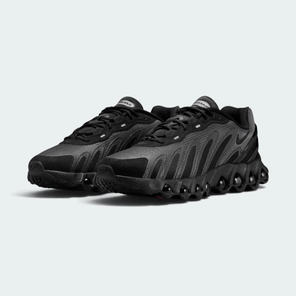 Focuses on the locked-in central lacing layout, displaying the symmetry of the black mesh tongues, dark laces, plush padded collars, and insoles printed with Air Max Dn logos.
