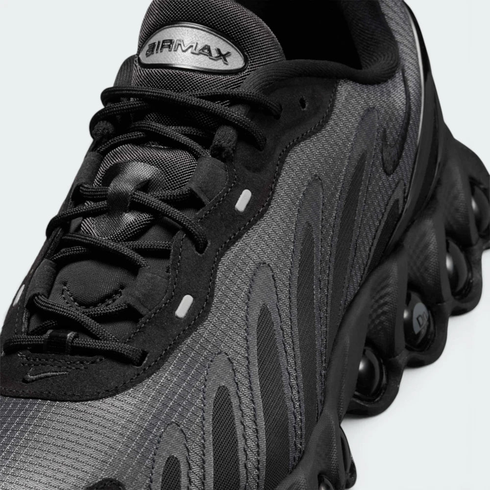 Focuses on the rear profile, highlighting the supportive plastic heel clip, debossed Dn logos, and the wide stance of the heel Air tubes.
