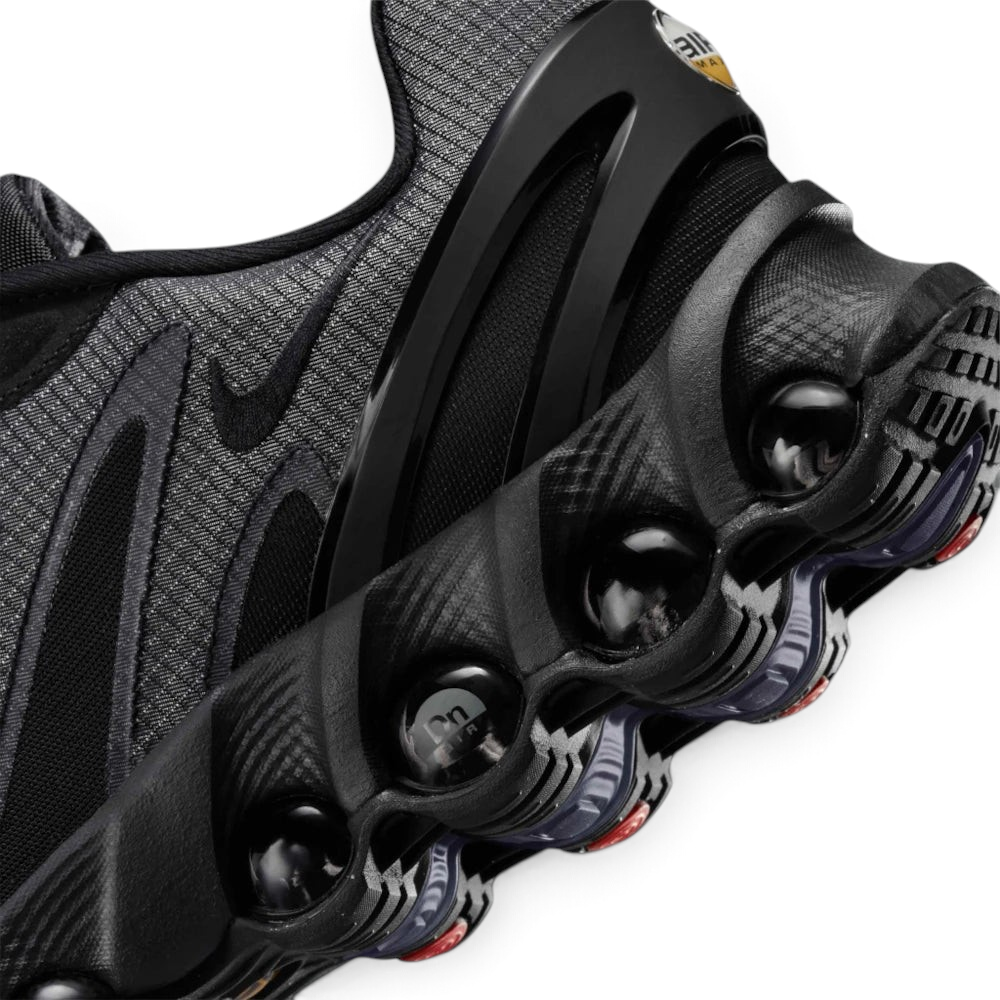 Details the micro-precision of the upper, showing the reinforced protective layer wrapping the toe tip, dark laces, and sleek tongue badge.