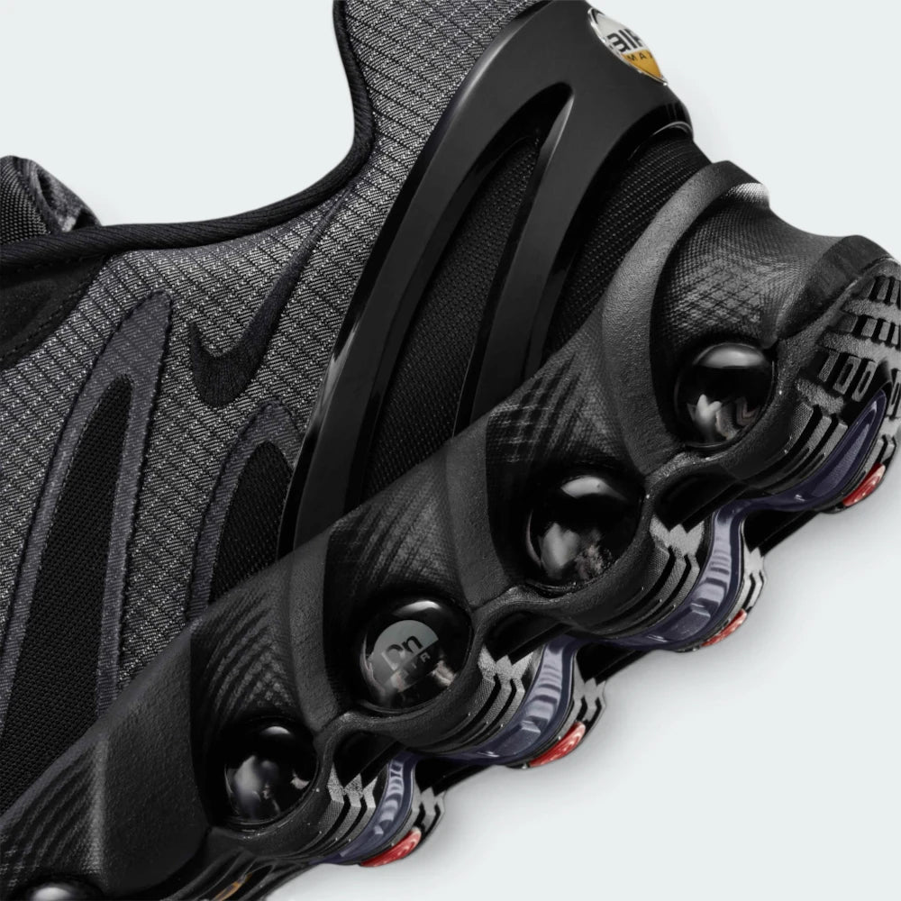 Details the micro-precision of the upper, showing the reinforced protective layer wrapping the toe tip, dark laces, and sleek tongue badge.