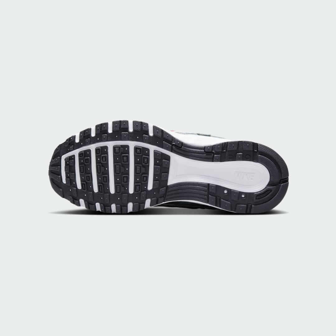 View of the outsole of the Nike P-6000 Juniors' silver trainers, showing the durable rubber tread pattern for everyday traction.