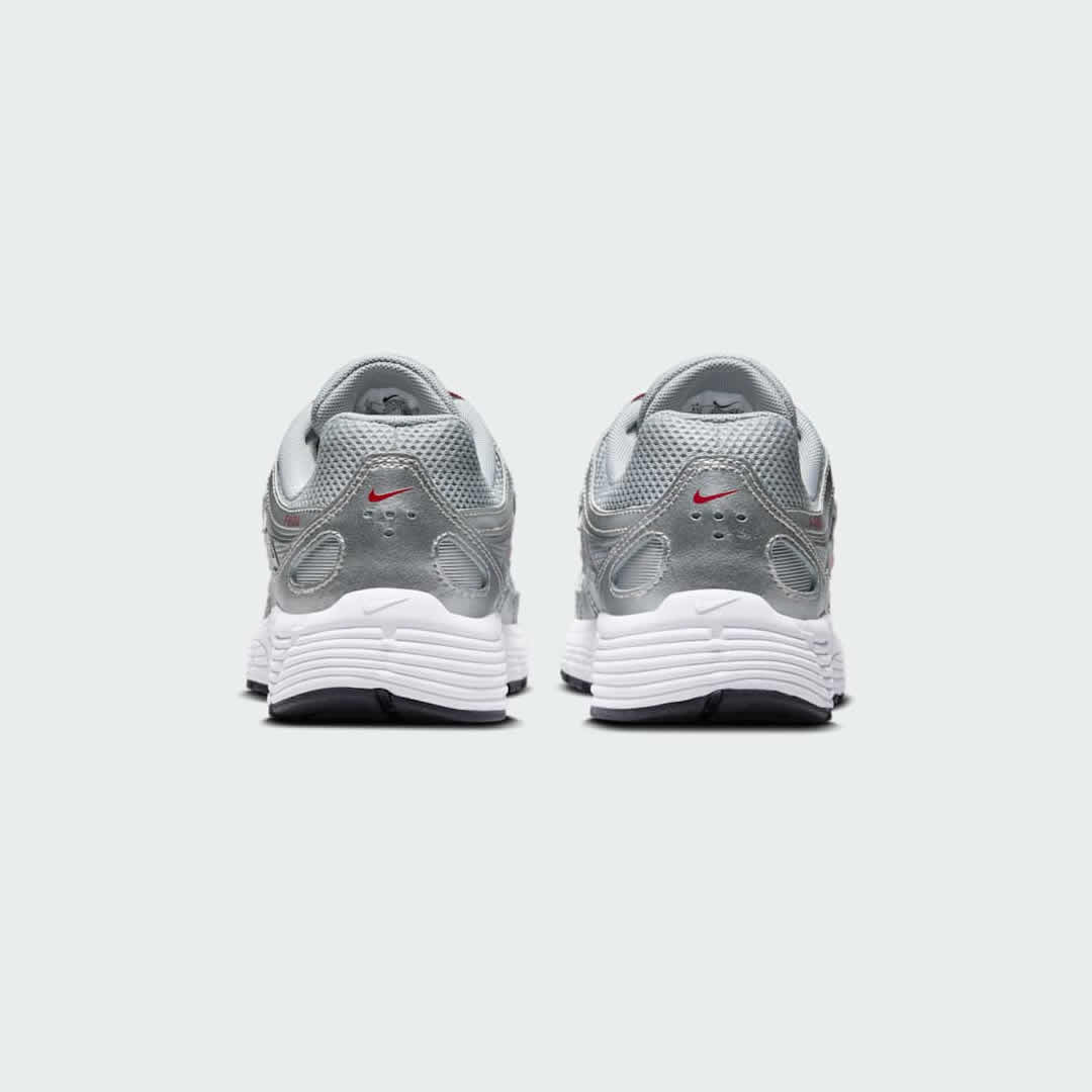 Rear view of the Nike P-6000 Juniors' silver trainers, focusing on the heel design, layered materials, and subtle branding.
