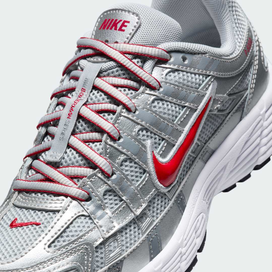 Close-up zoom on the front of the Nike P-6000 Juniors' silver trainers, showing the intricate mesh base, layered overlays, and lacing system.