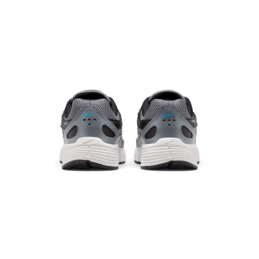 Close-up rear angle focusing on the segmented synthetic heel structure, central Nike P-6000 emblem, padded mesh collar lining, and the wrap-around foam midsole bumper.