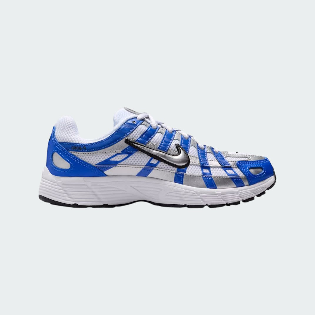 Nike P-6000 Juniors' trainers in racer blue with metallic silver accents, side profile showing layered mesh and synthetic overlays.