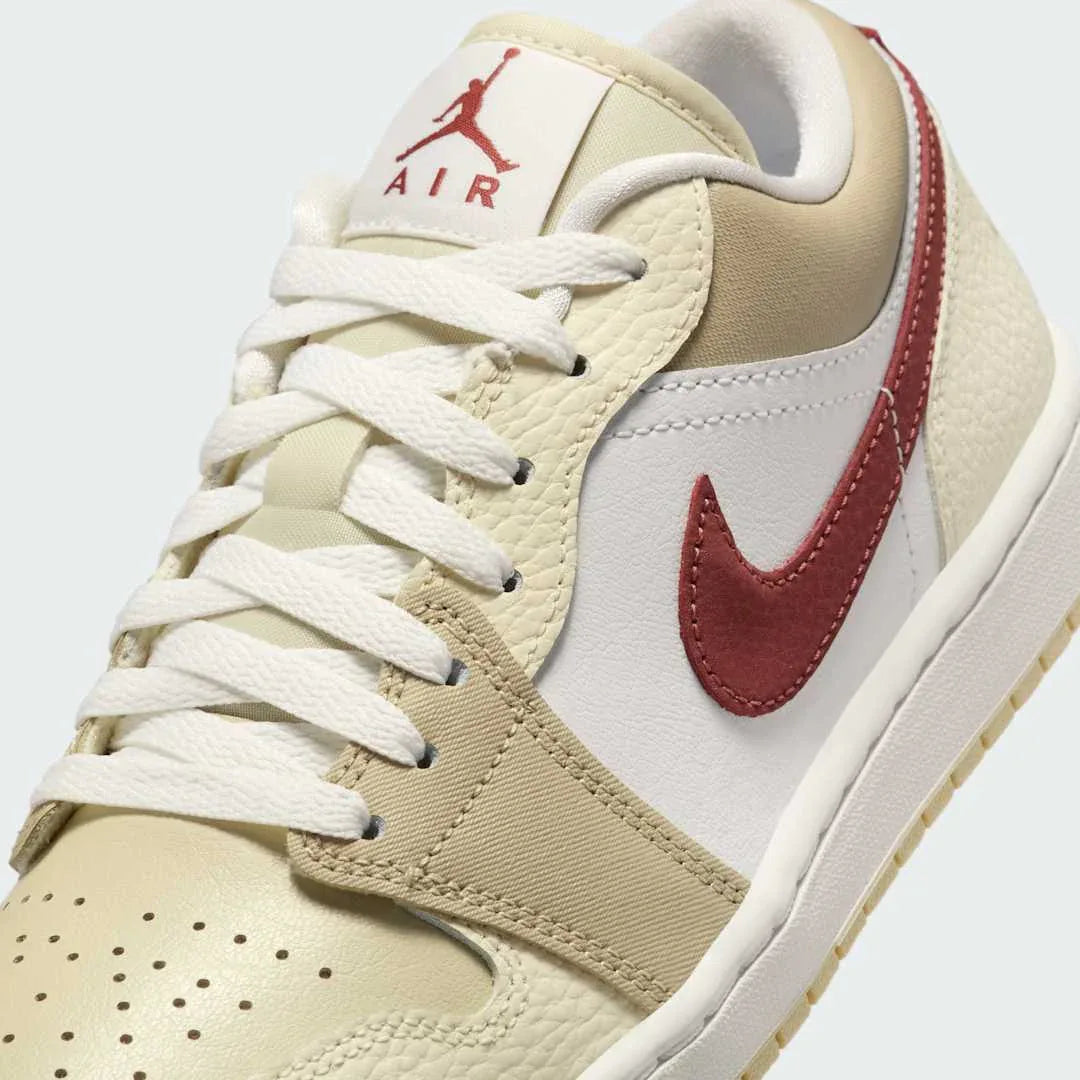 Close-up of Air Jordan 1 Low White Leather Trainers HV6530-100 showing tumbled leather texture, lace detail, and tongue branding