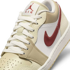 Close-up of Air Jordan 1 Low White Leather Trainers HV6530-100 showing tumbled leather texture, lace detail, and tongue branding