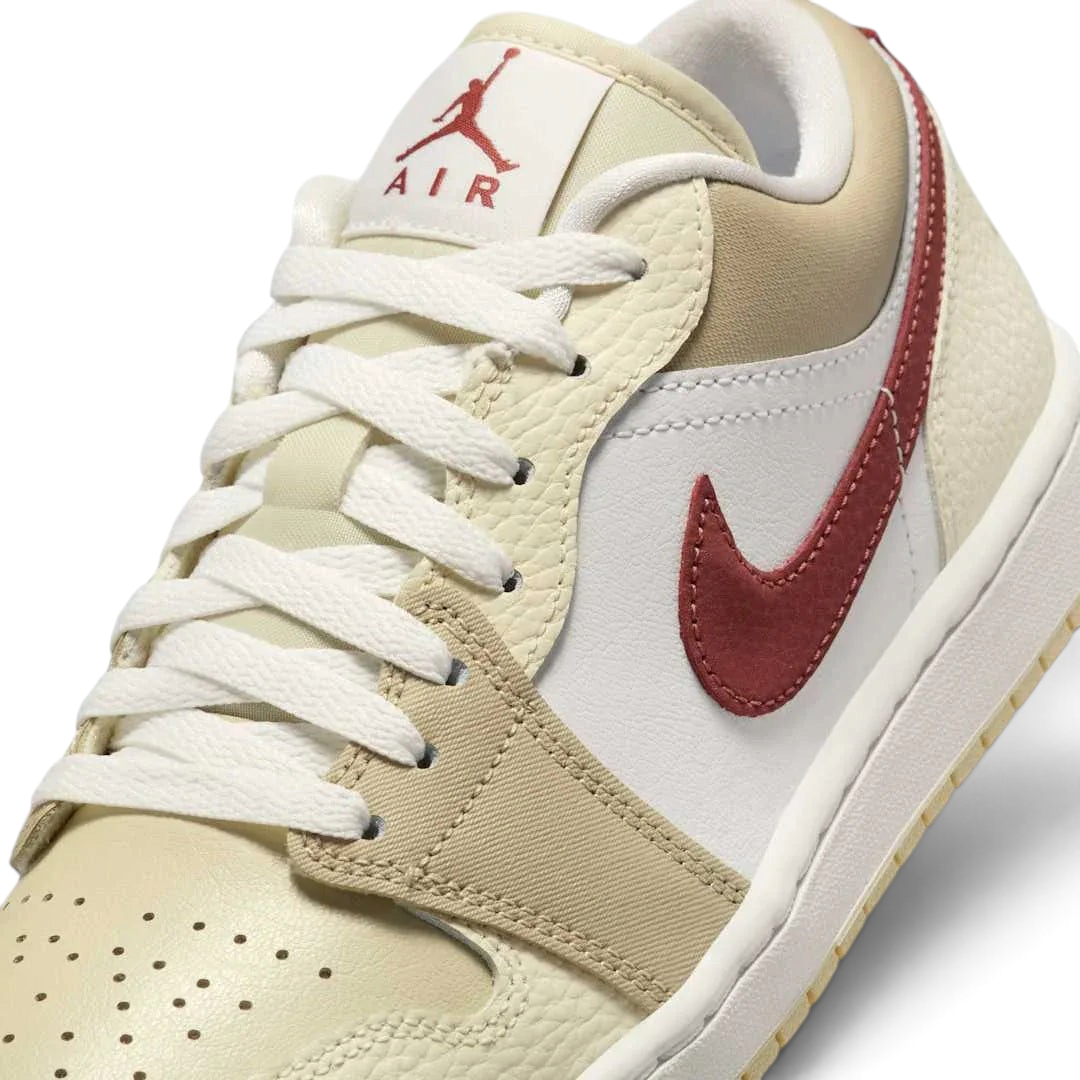 Close-up of Air Jordan 1 Low White Leather Trainers HV6530-100 showing tumbled leather texture, lace detail, and tongue branding