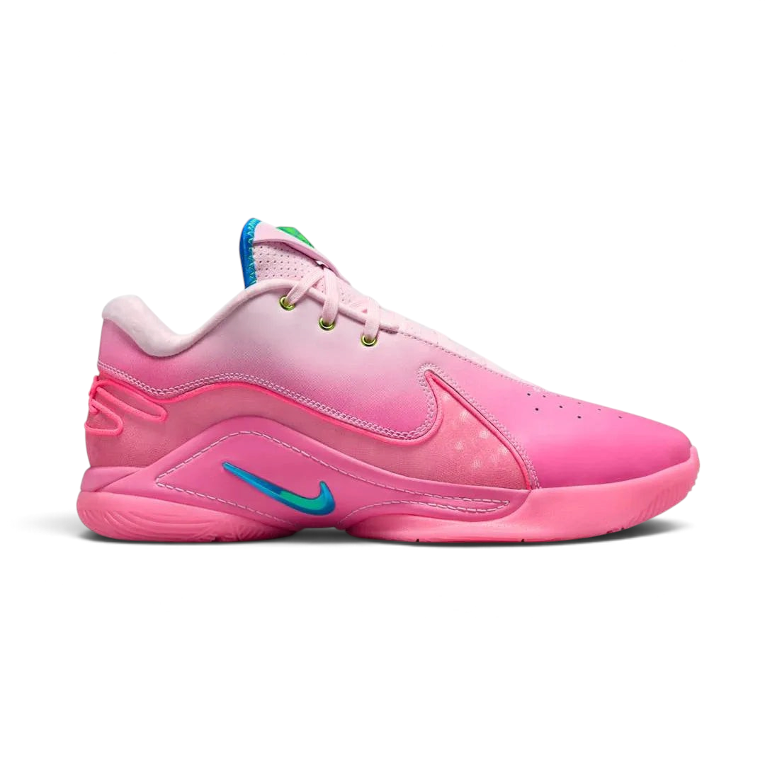 Nike LeBron XXII SN men's basketball trainer in pink foam/photo blue, side profile showing streamlined design, prominent Swoosh, and midfoot support wings.