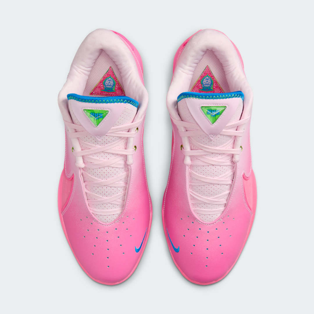 Top-down view of a pair of Nike LeBron XXII SN basketball trainers in vibrant pinks, highlighting the lacing system and textured upper.