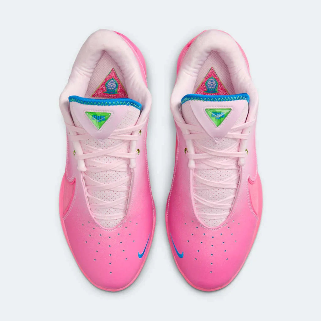 Top-down view of a pair of Nike LeBron XXII SN basketball trainers in vibrant pinks, highlighting the lacing system and textured upper.