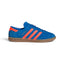 Highlights the sleek low-profile lateral silhouette featuring the rich Bluebird suede upper, vibrant Semi Solar Orange leather serrated 3-Stripes, metallic gold foil "HAMBURG" script, matching orange heel tab, and semi-translucent Gum 3 rubber cupsole with debossed adidas Trefoil branding.
