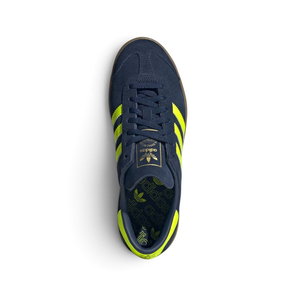 Focuses on the locked-in central lacing layout, displaying flat Night Indigo laces, thin suede tongues stamped with adidas Trefoil logo badges, reinforced T-toe overlays, and comfortable sockliners.